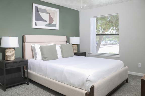 a bedroom with a large bed and a window