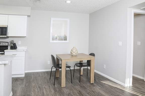 a kitchen and dining room with a table and chairs
