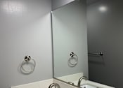 Thumbnail 2 of 9 - a bathroom with a sink and a mirror