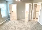 Thumbnail 10 of 60 - B1 (1-car) Master Bed looking into closet and bathroom