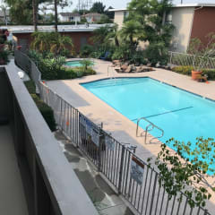 a view of the pool from the balcony of our apartment building