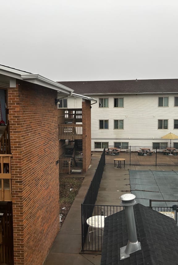 a view of the courtyard of a building from a balcony