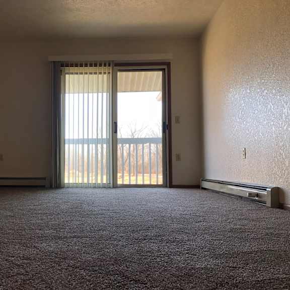 a white bedroom with a large bed and a window