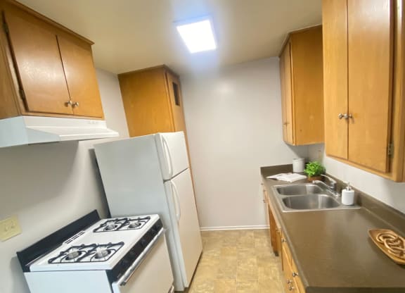 a small kitchen with two washes and a stove at Bowles Apts, California, 91702