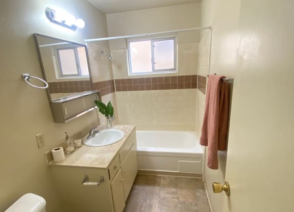 a small bathroom with a toilet and a shower at Bowles Apts, Azusa