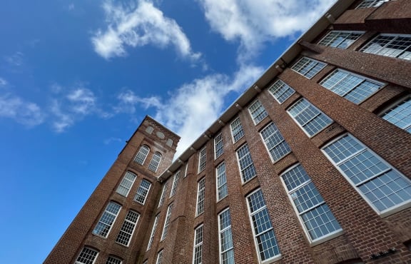 the facade of a brick building with a clock tower