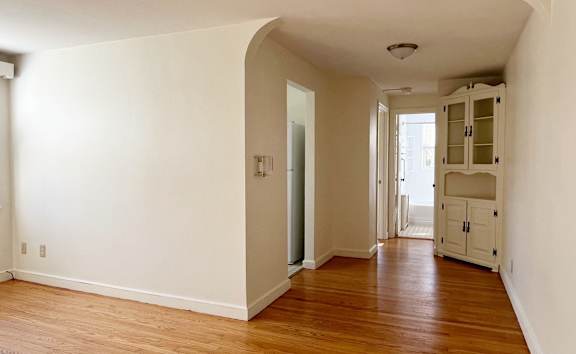 A room with wooden floors and white walls.