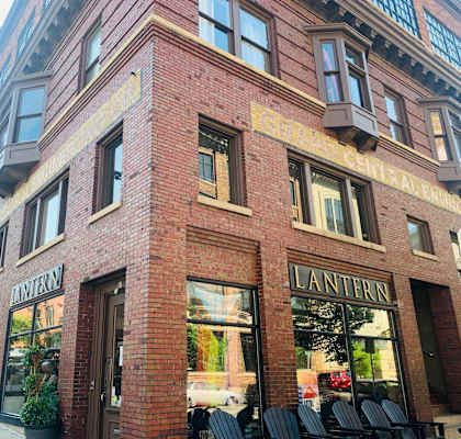 a brick building with chairs outside of it