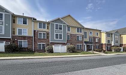 A row of townhouses with a clear blue sky above them.