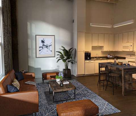 a view of a living room with a kitchen in the background at Lofts at Union Alley, Tennessee