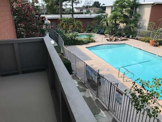 a view of the pool from the balcony of our apartment building
