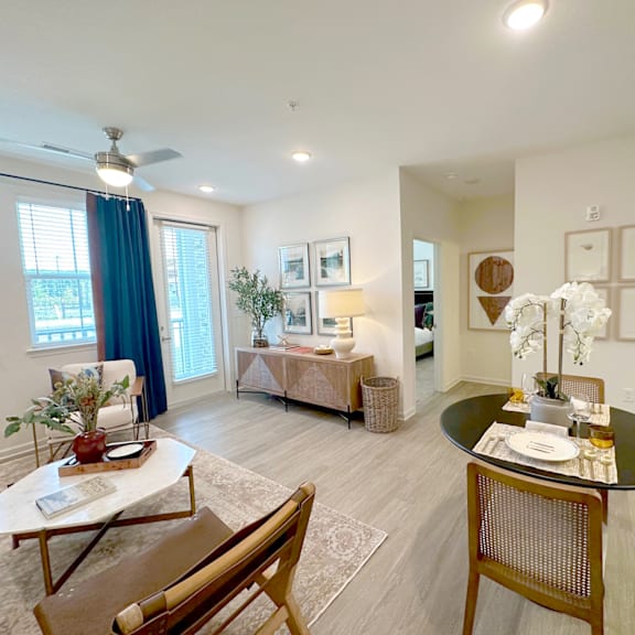 A living room with a dining table and chairs.