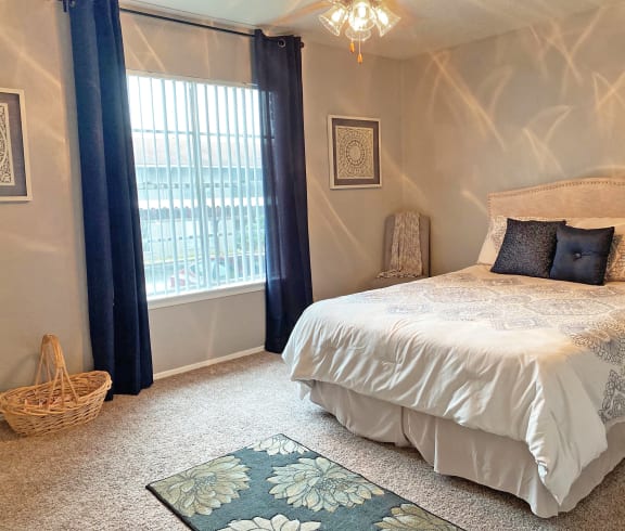 a bedroom with a large bed and a ceiling fan