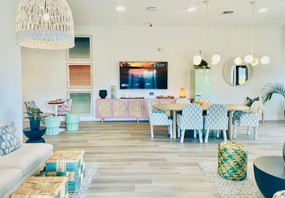 a living room with a table and chairs and a television at The Teale, Kissimmee, FL, 34746