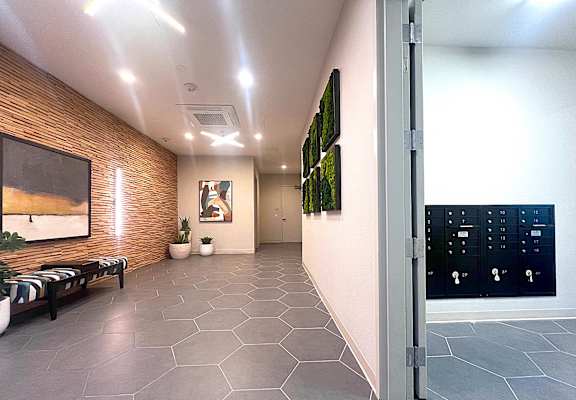 a hallway with a door to a room with a painting on the wall