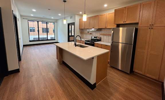 Kitchen View with brown cabinets at The Yard Apartments, Louisville