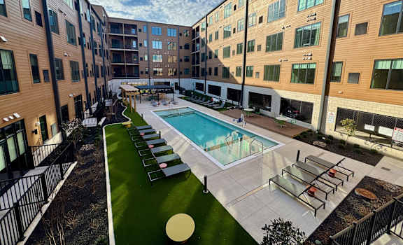 Resort style pool with sun loungers at The Yard Apartments, Louisville, 40202
