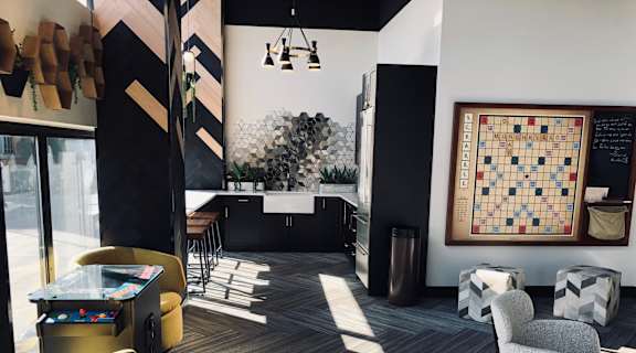 A room with a carpeted floor and a large window with sunlight coming through at Park Michigan Apartments, Chicago, 60605