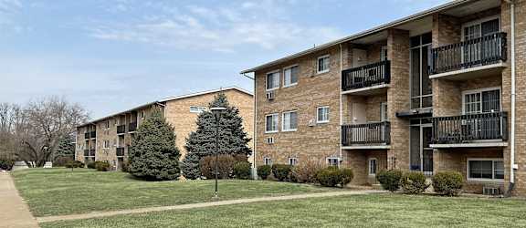 Apartment building with a green lawn in front.