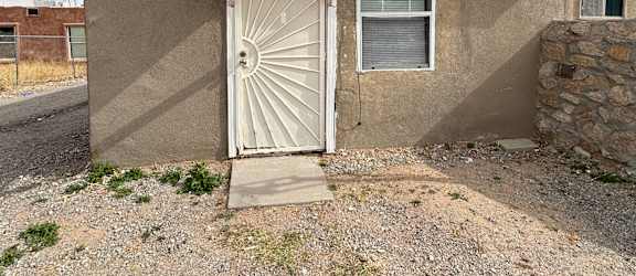 A small house with a white door and a window.