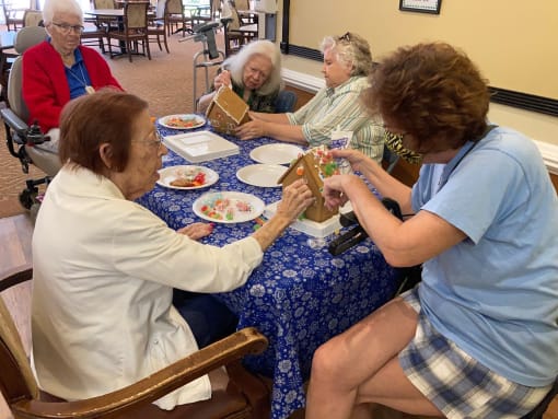 Residents Creating Gingerbread houses at Elison Independent Living of Lake Worth
