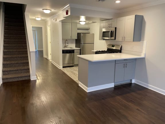 a kitchen with white cabinets and a white counter top