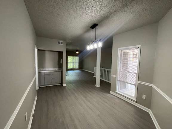 A room with a grey floor and white walls.