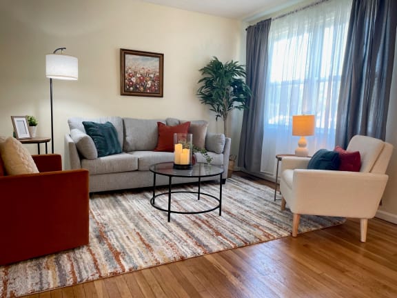 a living room filled with furniture and a large window