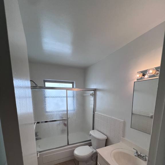 a small bathroom with a shower and a sink