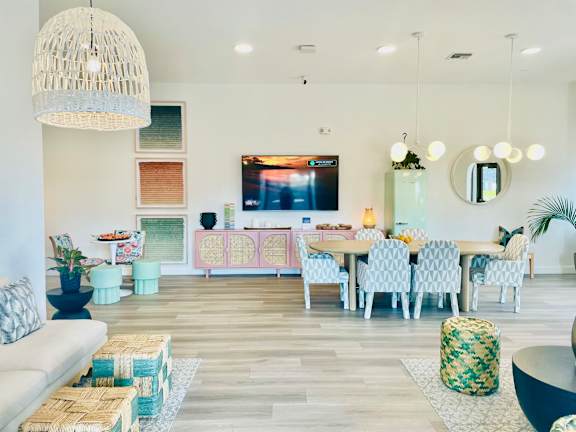 a living room with a table and chairs and a television at The Teale, Kissimmee, FL, 34746