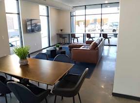 A conference room with a long table and chairs.