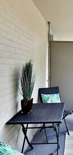 a living room with a couch and a table on a balcony