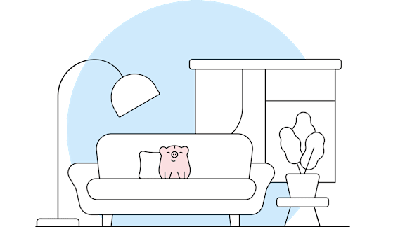 A cat is sitting on a couch with a lamp and a plant in the room.