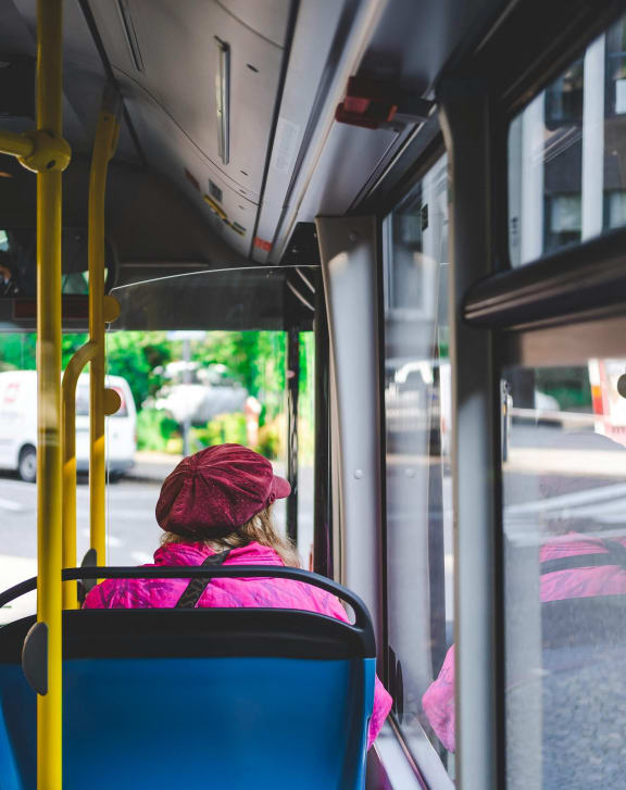 a woman sitting on a bus looking out the window