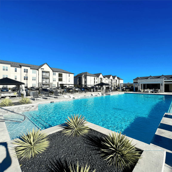 a large swimming pool in front of a building at The Fitzroy San Marcos, San Marcos, TX