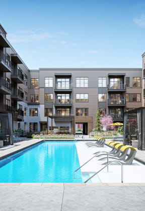 a swimming pool with chaise lounge chairs in front of an apartment building