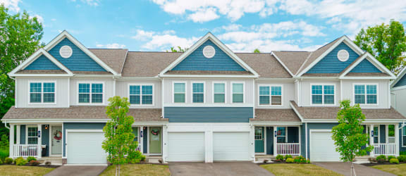a large house with blue siding and white doors