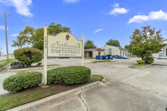 A sign for Northwood II, a 222-bedroom property, stands in front of a building.