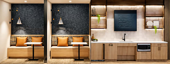A modern kitchen with a bar area and a blackboard on the wall.