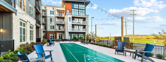 a basketball court on the patio of an apartment building with chairs and a basketball  at Vue at Westchester Commons, Midlothian, 23113