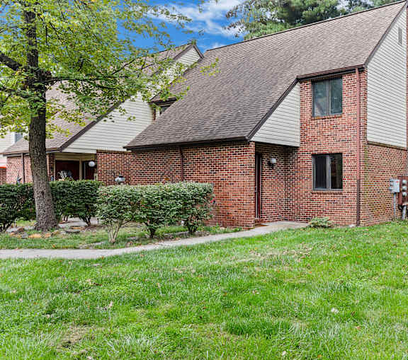 A house with a red brick exterior and a grey roof.