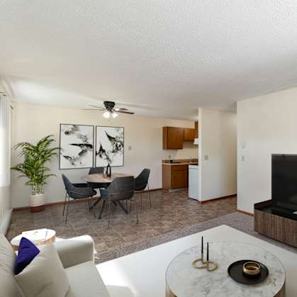 a living room with a couch and a table and a television. Hutchinson, MN Echo Manor Apartments