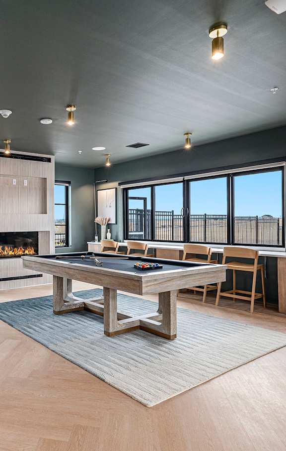 a kitchen and living room with black cabinets and a white
