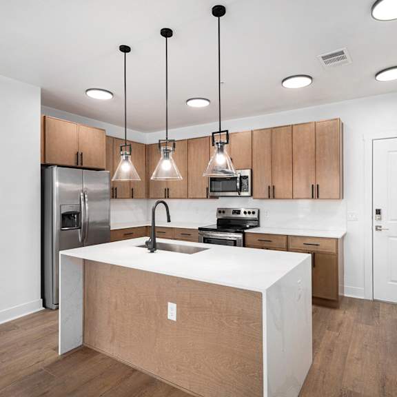 A kitchen with wooden cabinets and a white countertop.