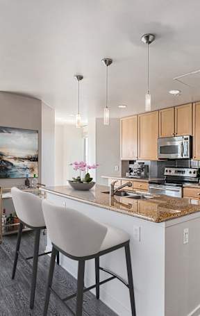 A modern kitchen with wooden cabinets and stainless steel appliances. at 1600 Glenarm Place, Colorado