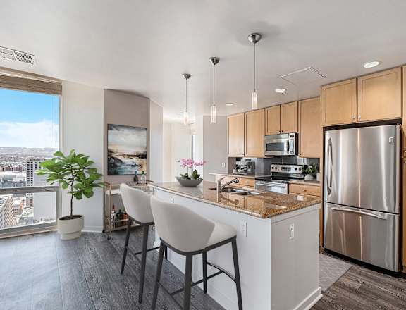 A modern kitchen with wooden cabinets and stainless steel appliances.