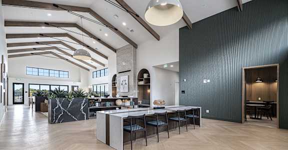 a large room with a table and chairs in the middle of it