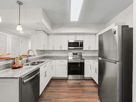 A modern kitchen with white cabinets and a central island.