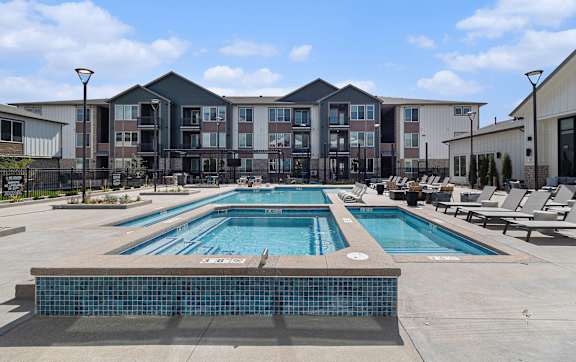A large swimming pool in front of a building.