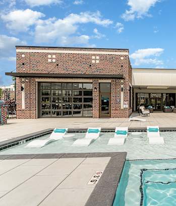 a brick building with a pool in front of it